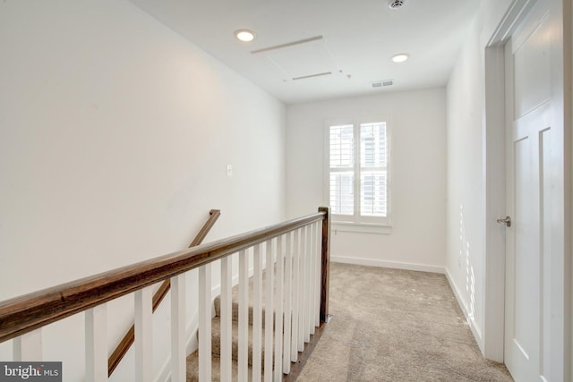 hall with light carpet, baseboards, visible vents, an upstairs landing, and recessed lighting