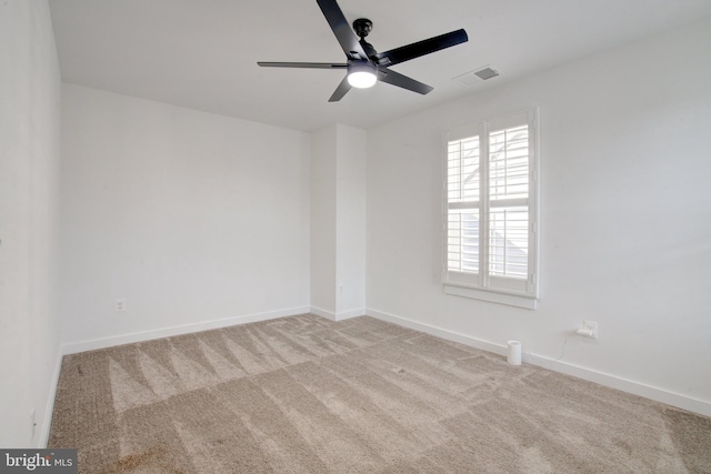 unfurnished room with baseboards, visible vents, ceiling fan, and light colored carpet