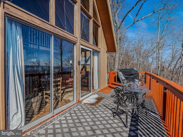 exterior space featuring a deck and a grill