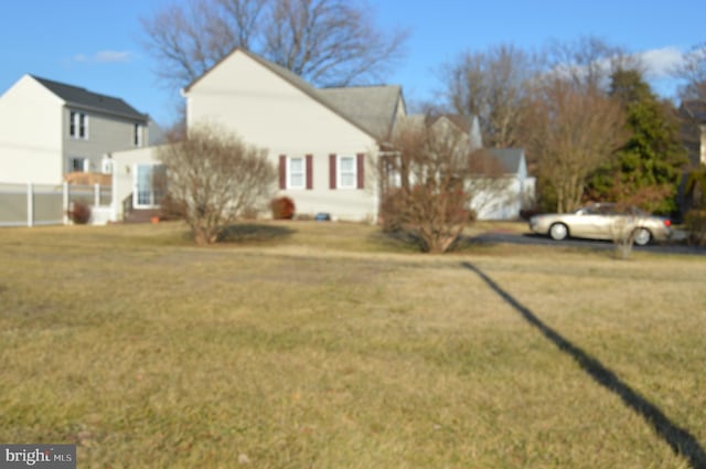 view of side of home with a yard