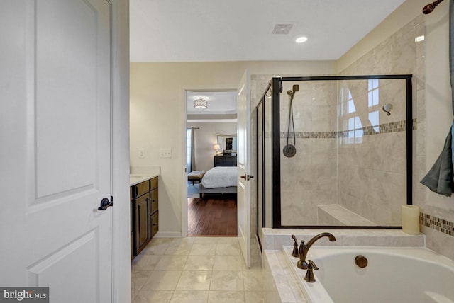 bathroom with vanity, tile patterned floors, and independent shower and bath