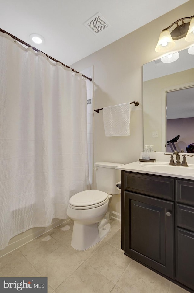 bathroom with vanity, tile patterned floors, and toilet