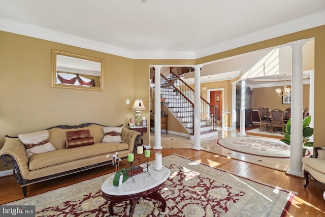 living room with ornamental molding, ornate columns, and wood-type flooring