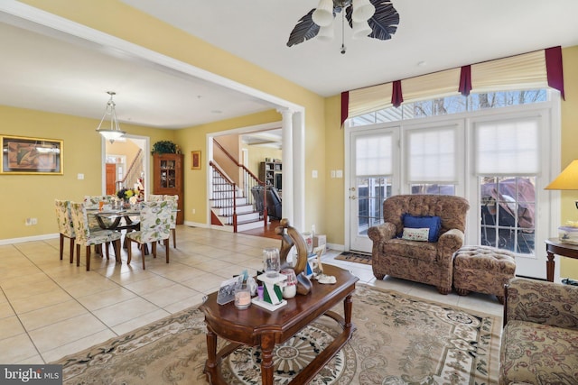 tiled living room with ceiling fan