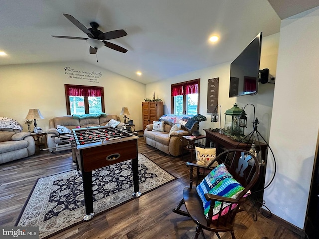 game room with dark hardwood / wood-style flooring, vaulted ceiling, and ceiling fan