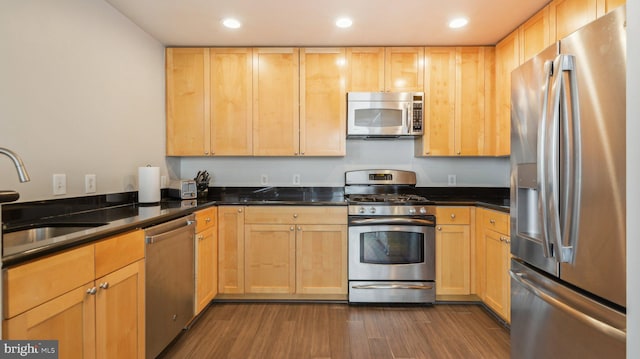 kitchen featuring light brown cabinetry, sink, dark wood-type flooring, and appliances with stainless steel finishes