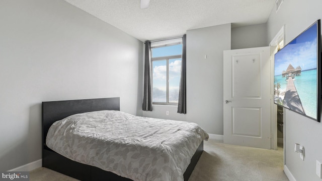 bedroom with carpet flooring and a textured ceiling