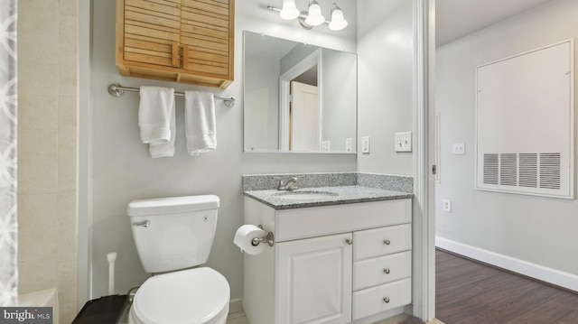 bathroom with vanity, hardwood / wood-style floors, curtained shower, and toilet