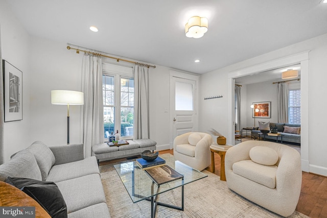 living area with recessed lighting, wood finished floors, and baseboards