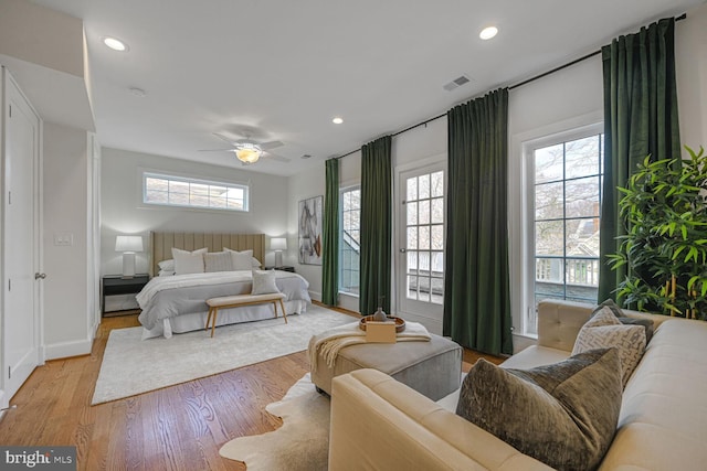 bedroom with light wood-type flooring, visible vents, baseboards, and recessed lighting