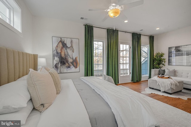 bedroom with recessed lighting, visible vents, multiple windows, and wood finished floors