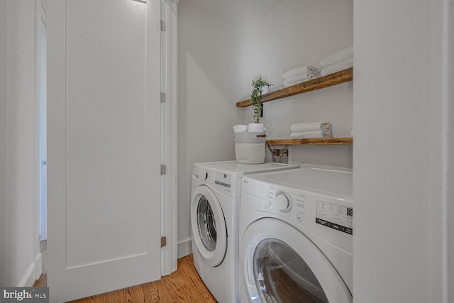 laundry area featuring light wood-type flooring, laundry area, and washing machine and dryer