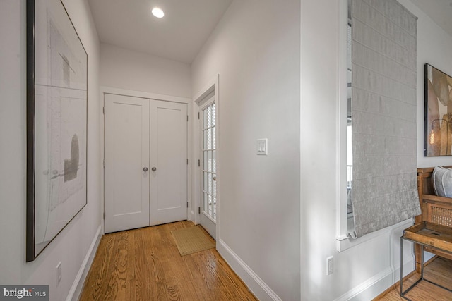 interior space with baseboards, wood finished floors, and recessed lighting