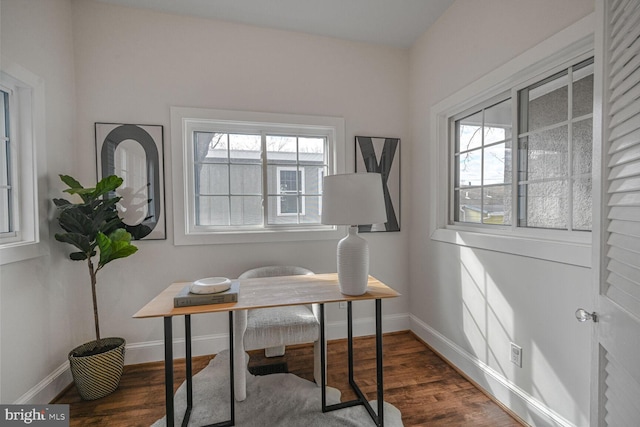 office featuring baseboards, dark wood-type flooring, and a wealth of natural light