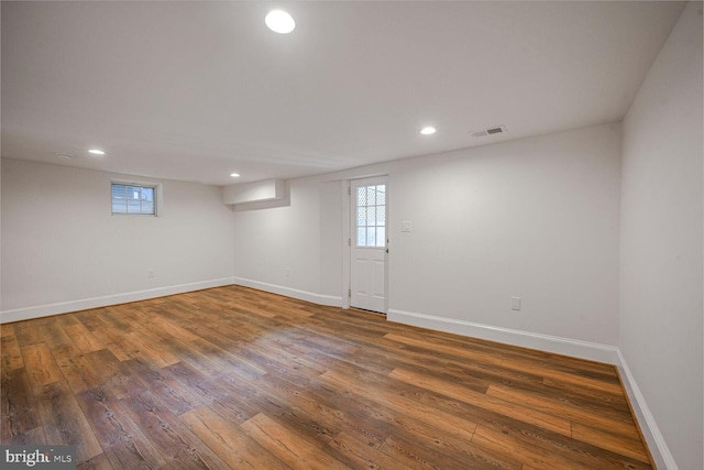 basement with recessed lighting, visible vents, baseboards, and wood finished floors