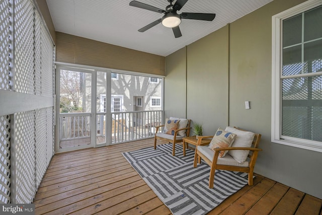 sunroom featuring ceiling fan