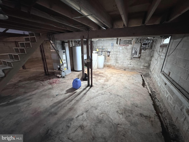 basement with electric panel, heating unit, and gas water heater