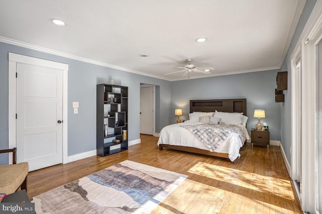 bedroom featuring crown molding, ceiling fan, and hardwood / wood-style floors