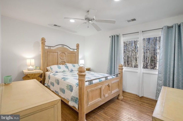 bedroom with ceiling fan and wood-type flooring