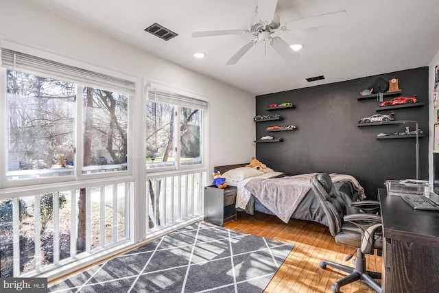 bedroom with hardwood / wood-style floors and ceiling fan