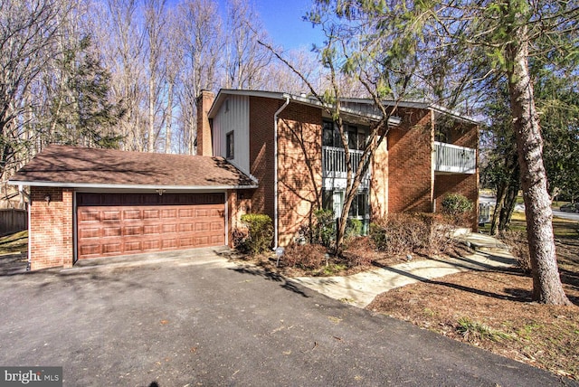 view of front facade featuring a garage and a balcony