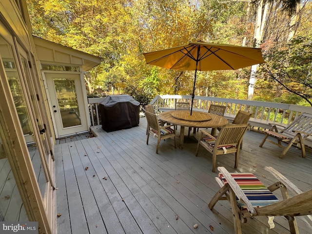 wooden terrace with a grill