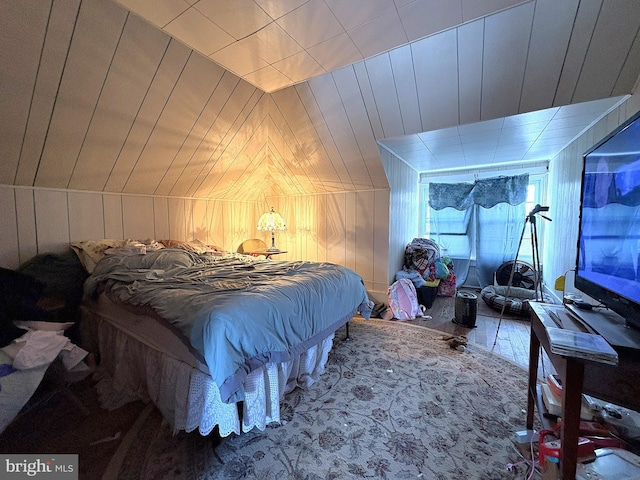 bedroom with wood walls