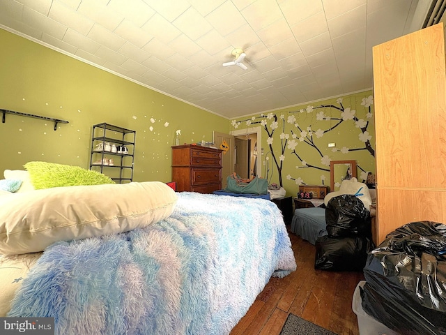 bedroom with crown molding and dark hardwood / wood-style flooring