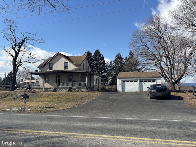 view of front facade with a garage, an outdoor structure, and covered porch