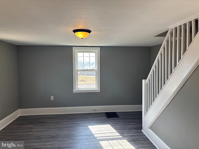 spare room with dark hardwood / wood-style flooring