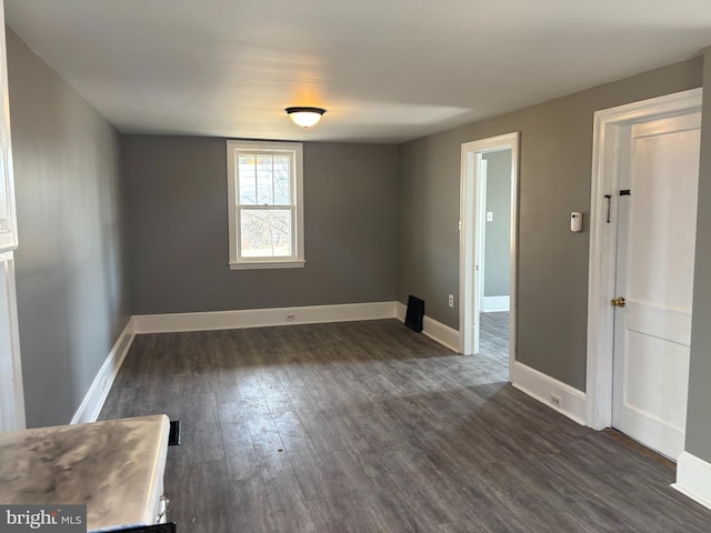 spare room featuring dark hardwood / wood-style floors