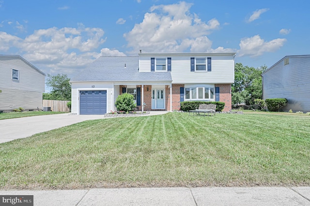 view of property with a garage and a front lawn