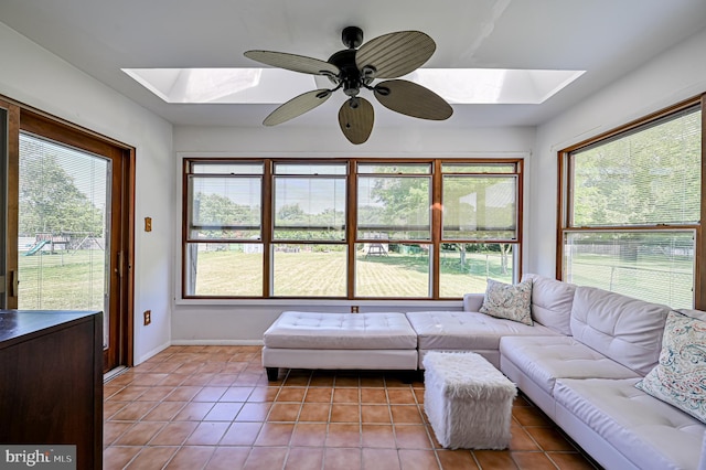 tiled living room featuring plenty of natural light and a skylight