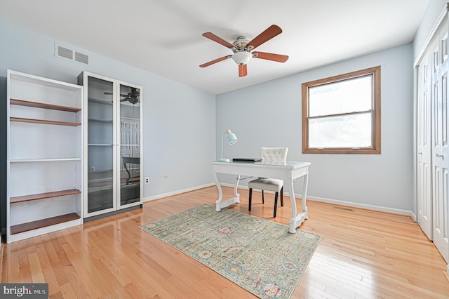 office space with ceiling fan and light hardwood / wood-style floors