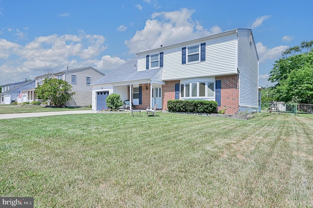 view of front facade featuring a garage, a front yard, and a porch