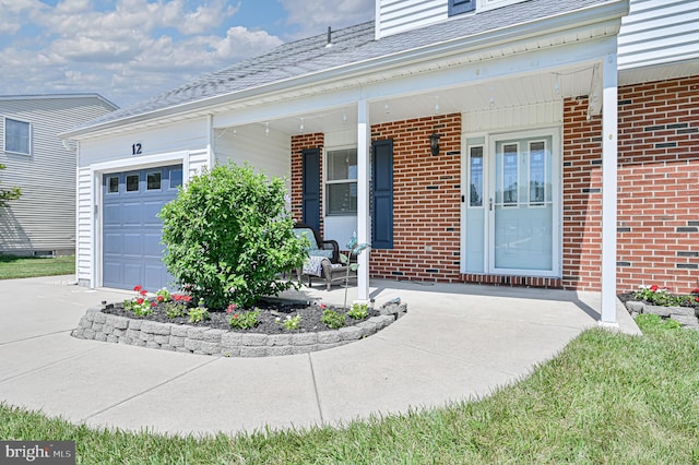 entrance to property with a garage and covered porch