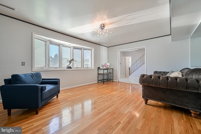 living room featuring an inviting chandelier and light hardwood / wood-style floors