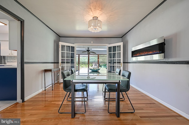 dining space with ceiling fan, ornamental molding, and light wood-type flooring