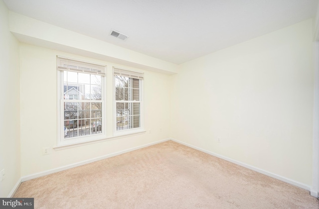 empty room featuring light colored carpet