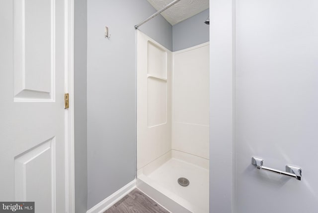 bathroom featuring hardwood / wood-style floors and a shower