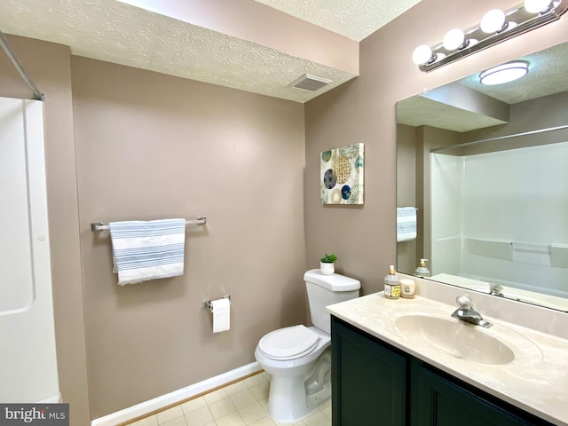 bathroom featuring tile patterned floors, toilet, a shower, a textured ceiling, and vanity