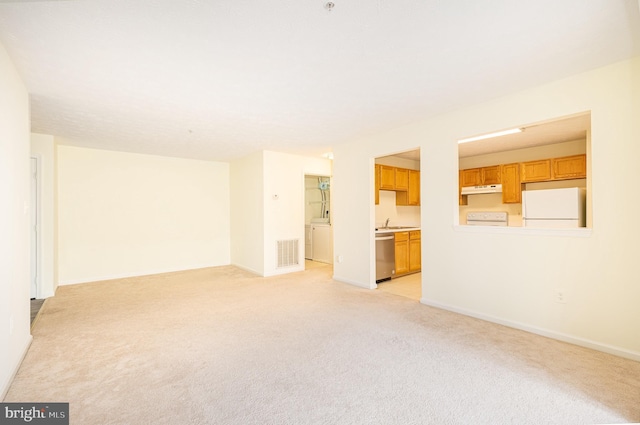 carpeted spare room featuring sink