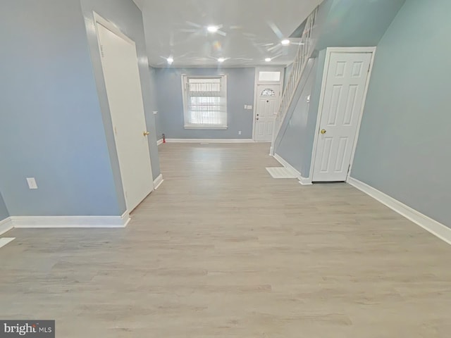 corridor with light hardwood / wood-style floors