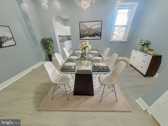 dining space featuring a notable chandelier and light hardwood / wood-style flooring