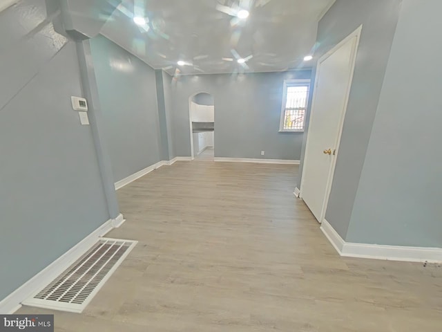 hallway with light hardwood / wood-style flooring