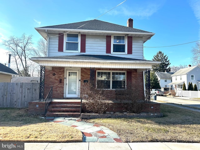 view of front property with a front yard and covered porch