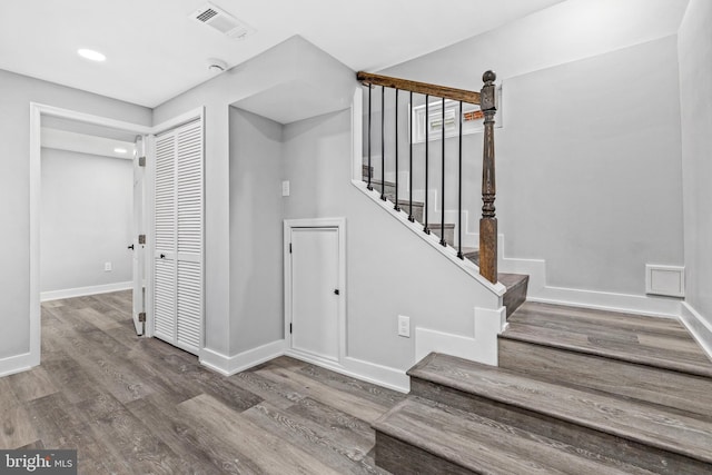 stairs with hardwood / wood-style flooring