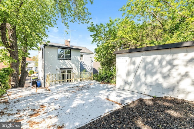 back of house featuring a patio and a shed