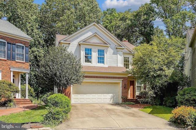 view of front of house featuring driveway, a garage, a shingled roof, a chimney, and brick siding