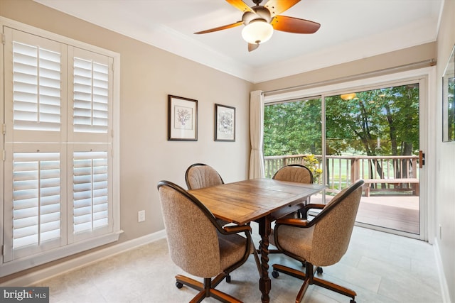 dining room with ceiling fan, baseboards, and ornamental molding